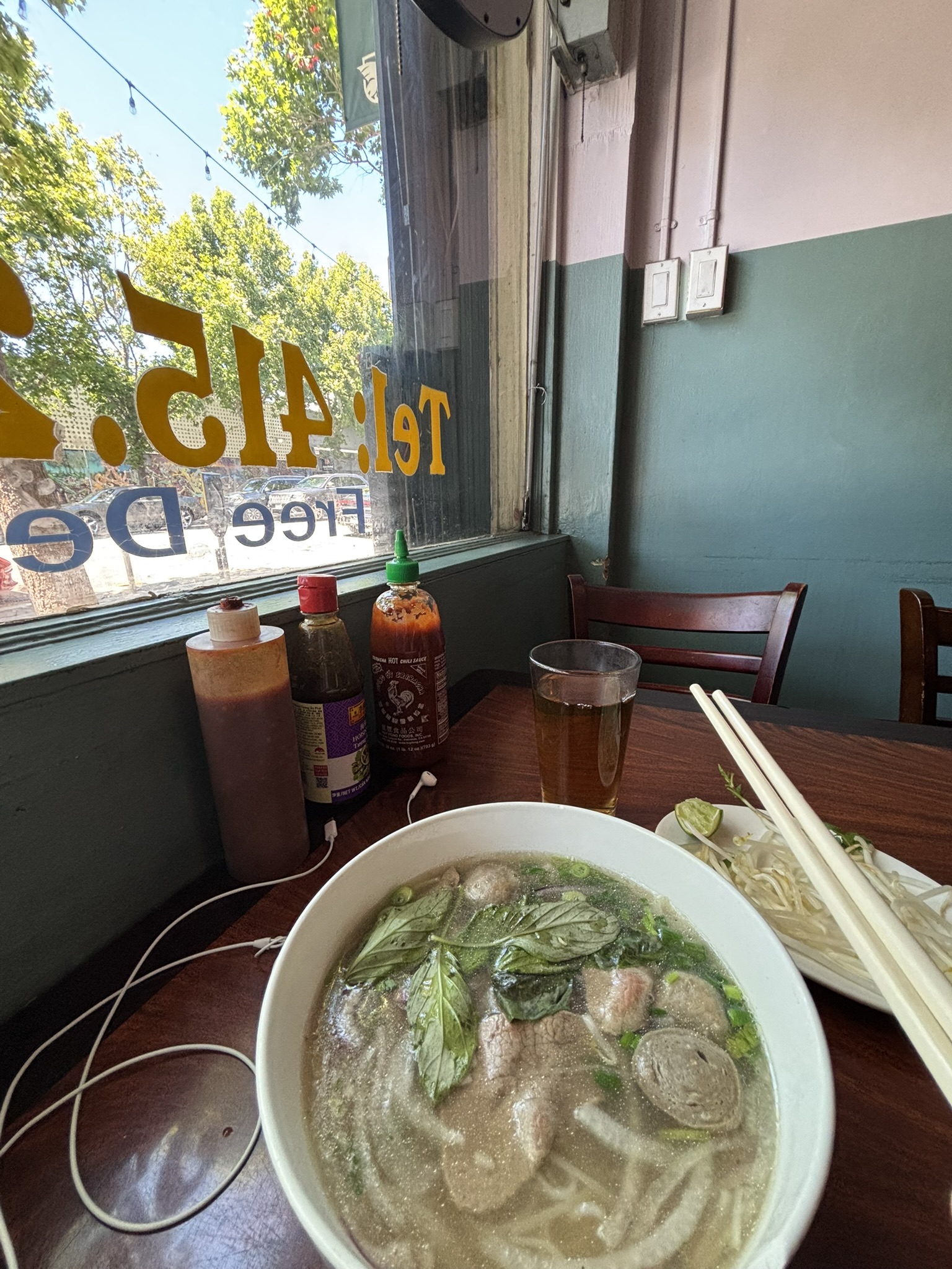 picture of my bowl of pho by a window seat
