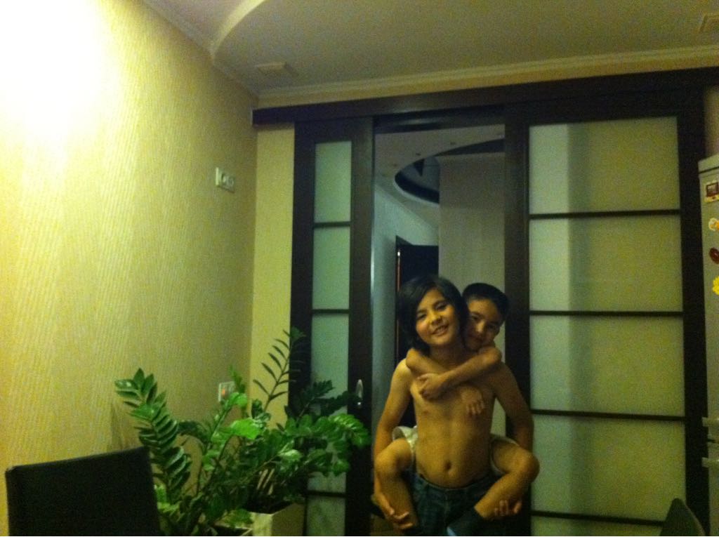 childhood picture of me holding my brother on my back